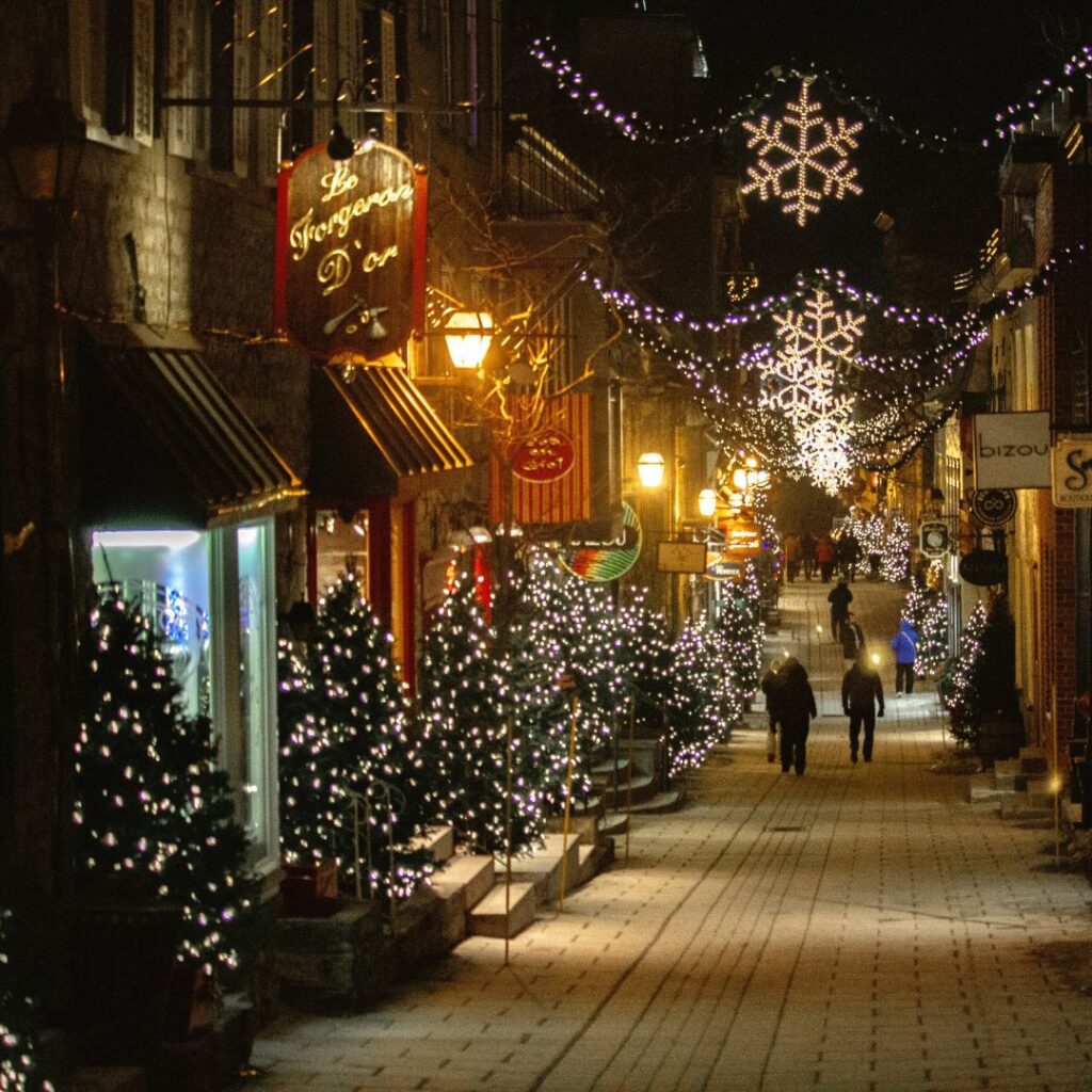 festive lights down a town highstreet in winter